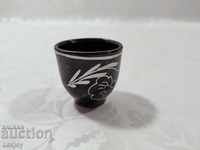 A small ceramic cup