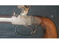 old capsule pistol with two barrels