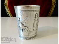 Tin cup with embossed picture.