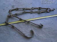 Old wrought iron chain with hook, twisted iron hook