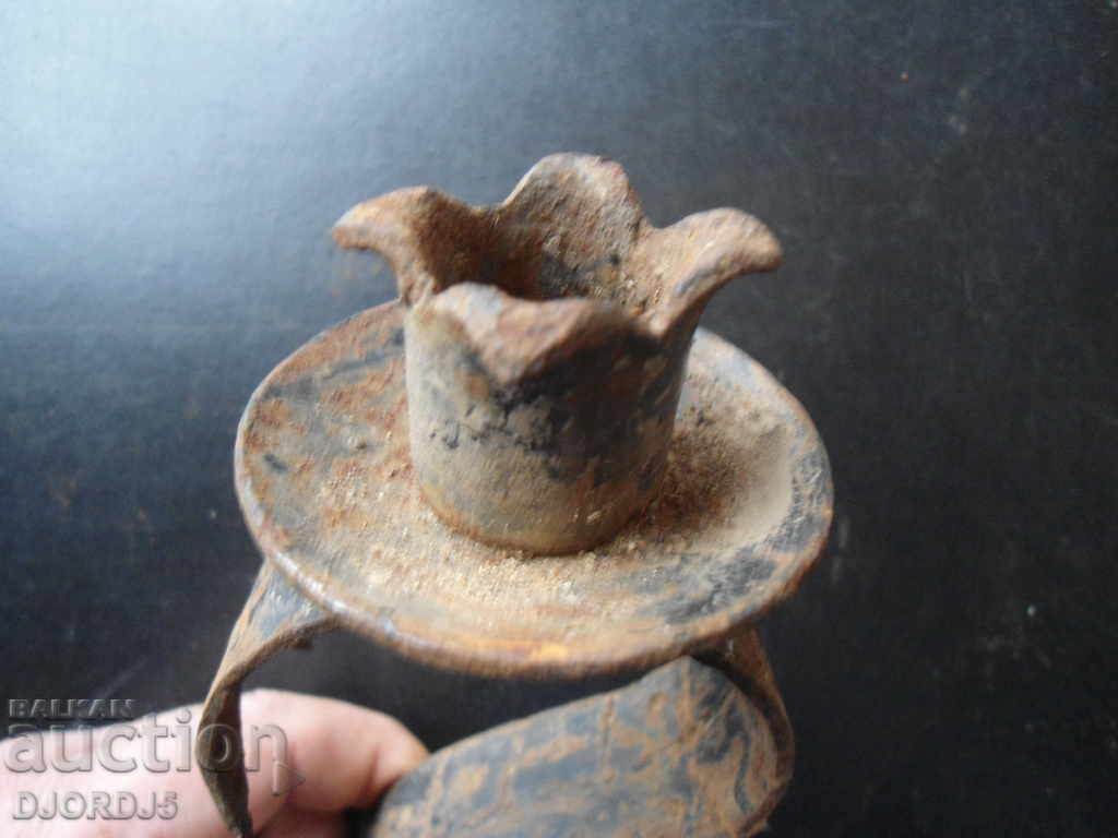 Auction  An old forged candlestick