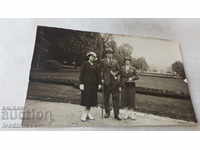 Photo of a man and two women in the park