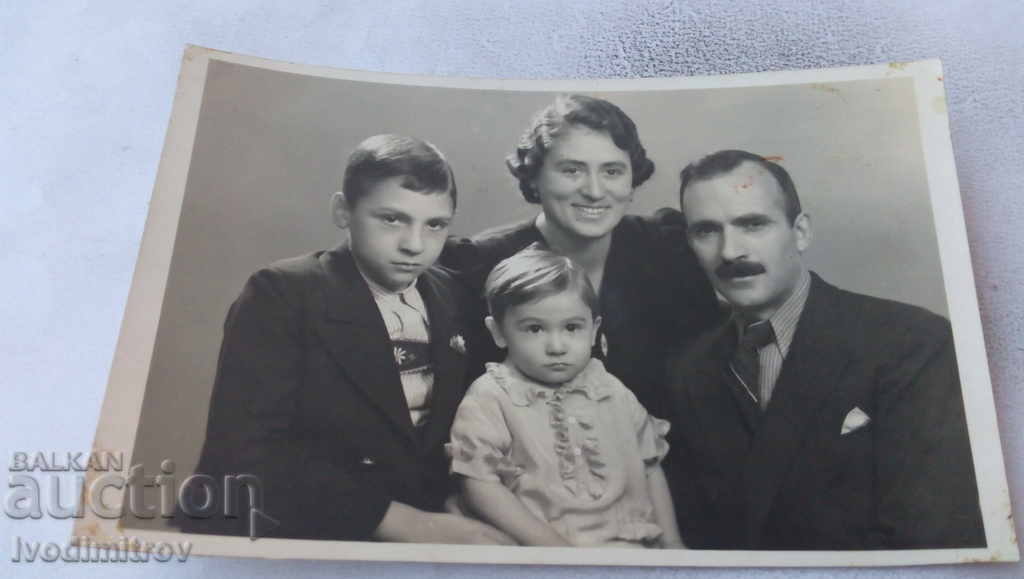 Photo of a man and two women with their two children