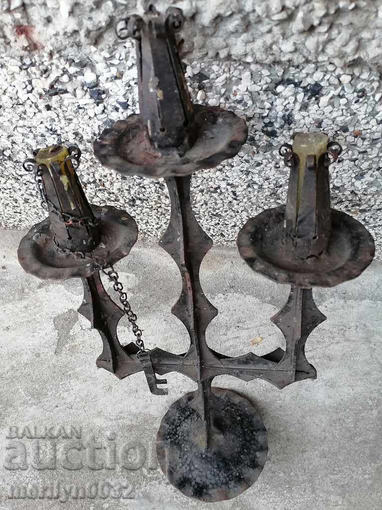 Delivery of An old forged candlestick from a period period candle Delivery of An old forged candlestick from a period period candle