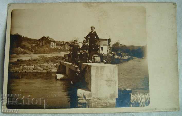 Old photo soldiers sailors on a dam bridge