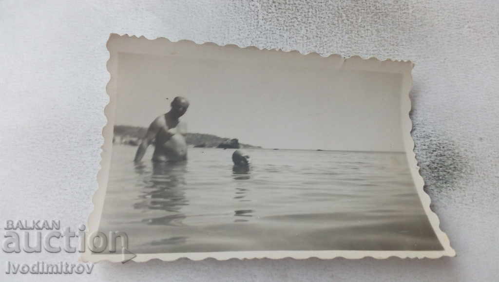 Photo Two men bathe in the sea