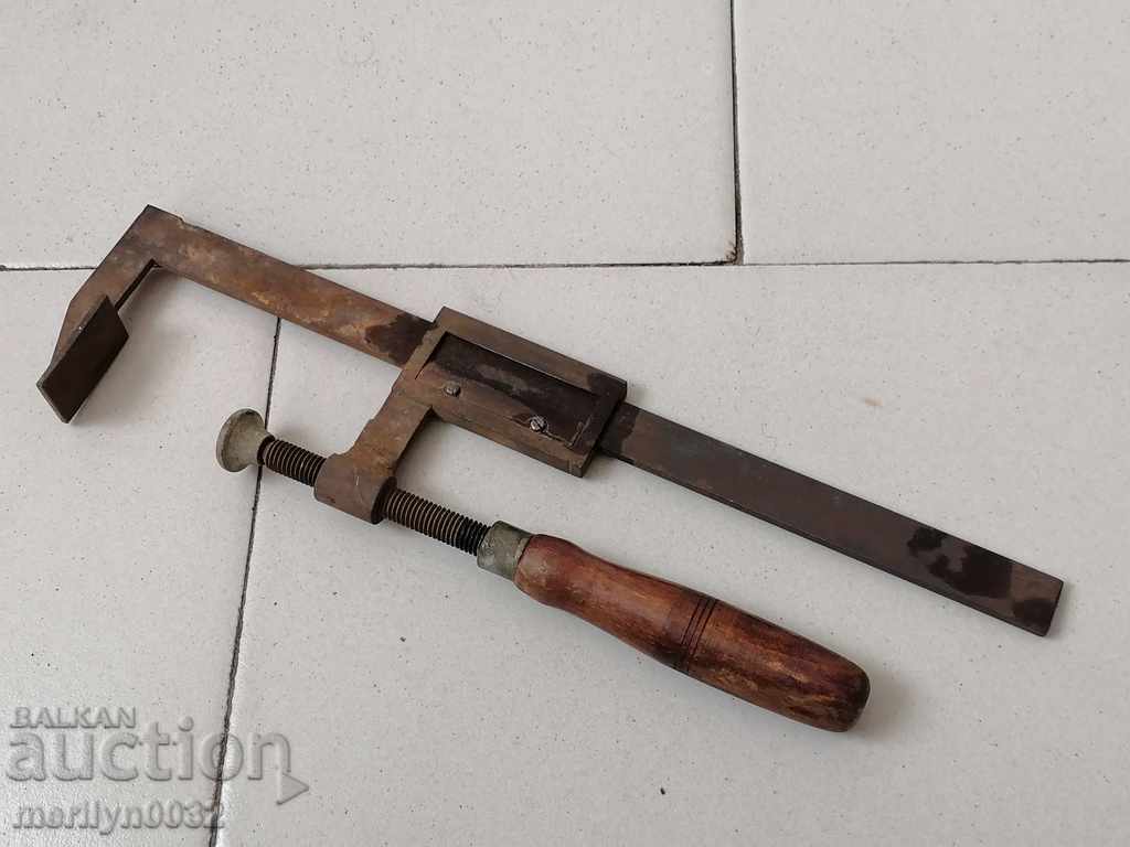 An old carpenter's clamp, a socket, a wooden tool