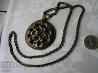 Brass amulet with chain.