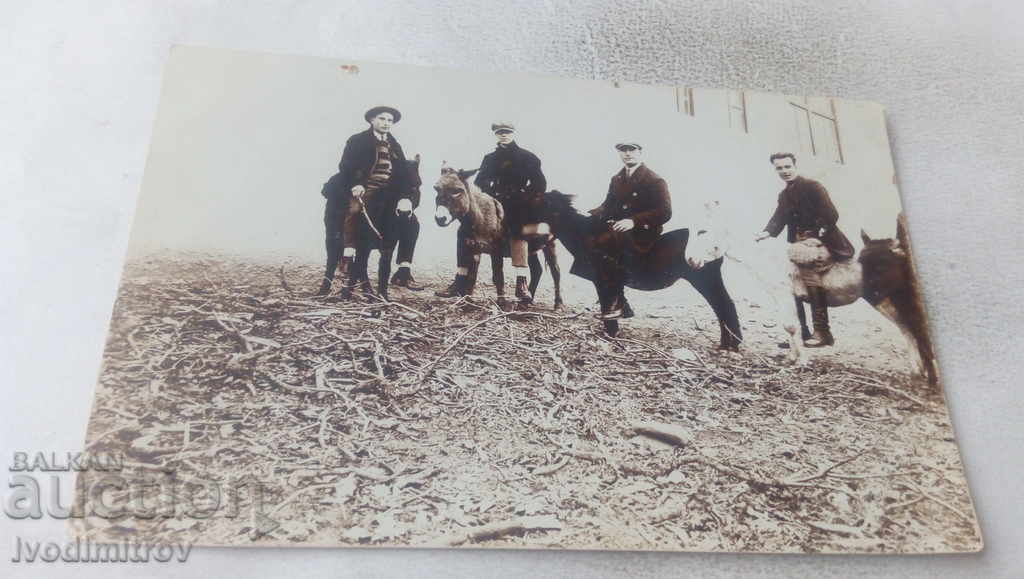 Photo Four men on donkeys