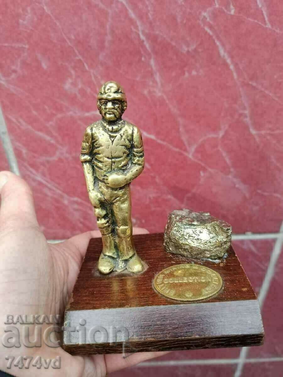 Bronze sculpture Miner with pyrite I think is the stone. Bronze sculpture Miner with pyrite I think is the stone.