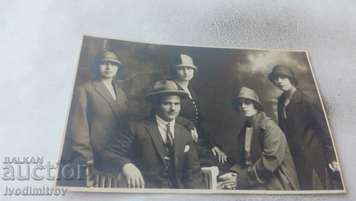 Photo of a man and four young women