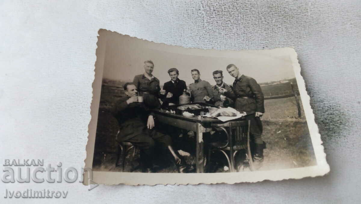 Φωτογραφία Αξιωματικοί και στρατιώτες γύρω από ένα τραπέζι με ένα ψητό γουρούνι