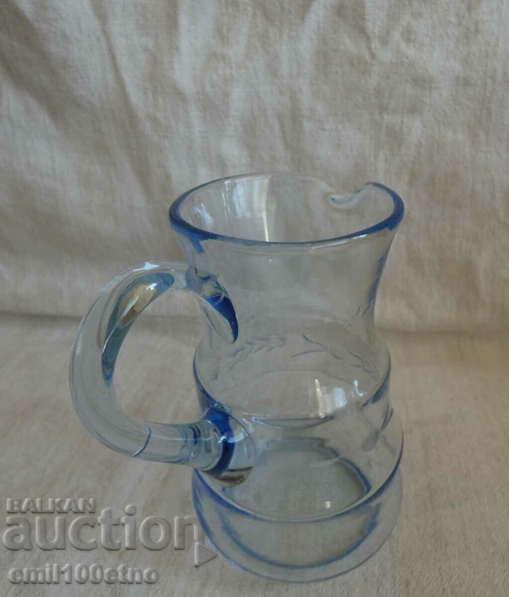Delivery of A small beautiful jug of blue engraved glass Delivery of A small beautiful jug of blue engraved glass