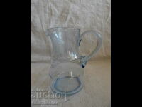 A small beautiful jug of blue engraved glass