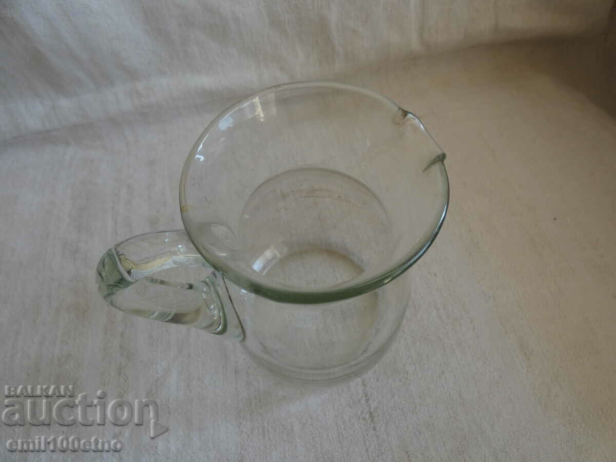Auction A small glass jug Auction A small glass jug