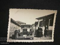 Παλιά άτομα φωτογραφιών δίπλα σε ένα ρετρό αυτοκίνητο