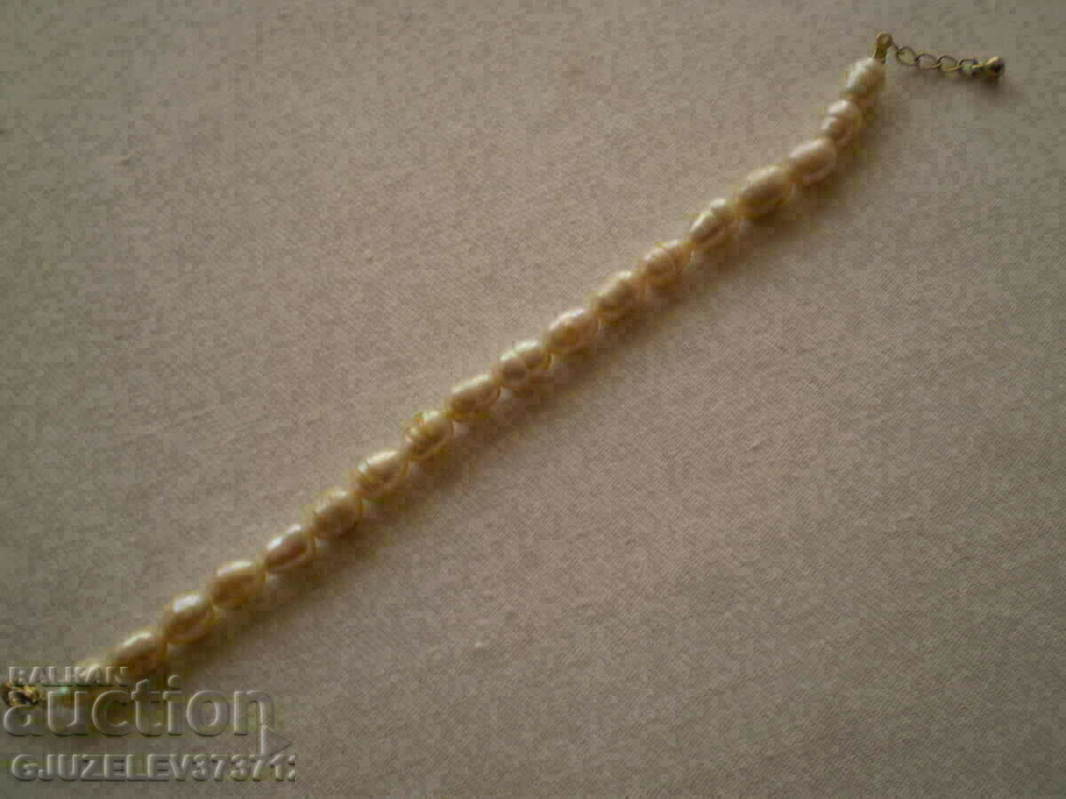Auction bracelet made of natural white river pearls is made by hand Auction bracelet made of natural white river pearls is made by hand