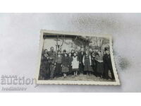 Photo Men women and children in front of a house 1943