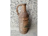An old knit wreath, bottle with braid, bottle, glass