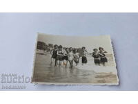 Φωτογραφία Νεαρός άνδρας και κορίτσια στη θάλασσα