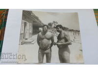 Foto Doi bărbați în costume de baie pe plajă