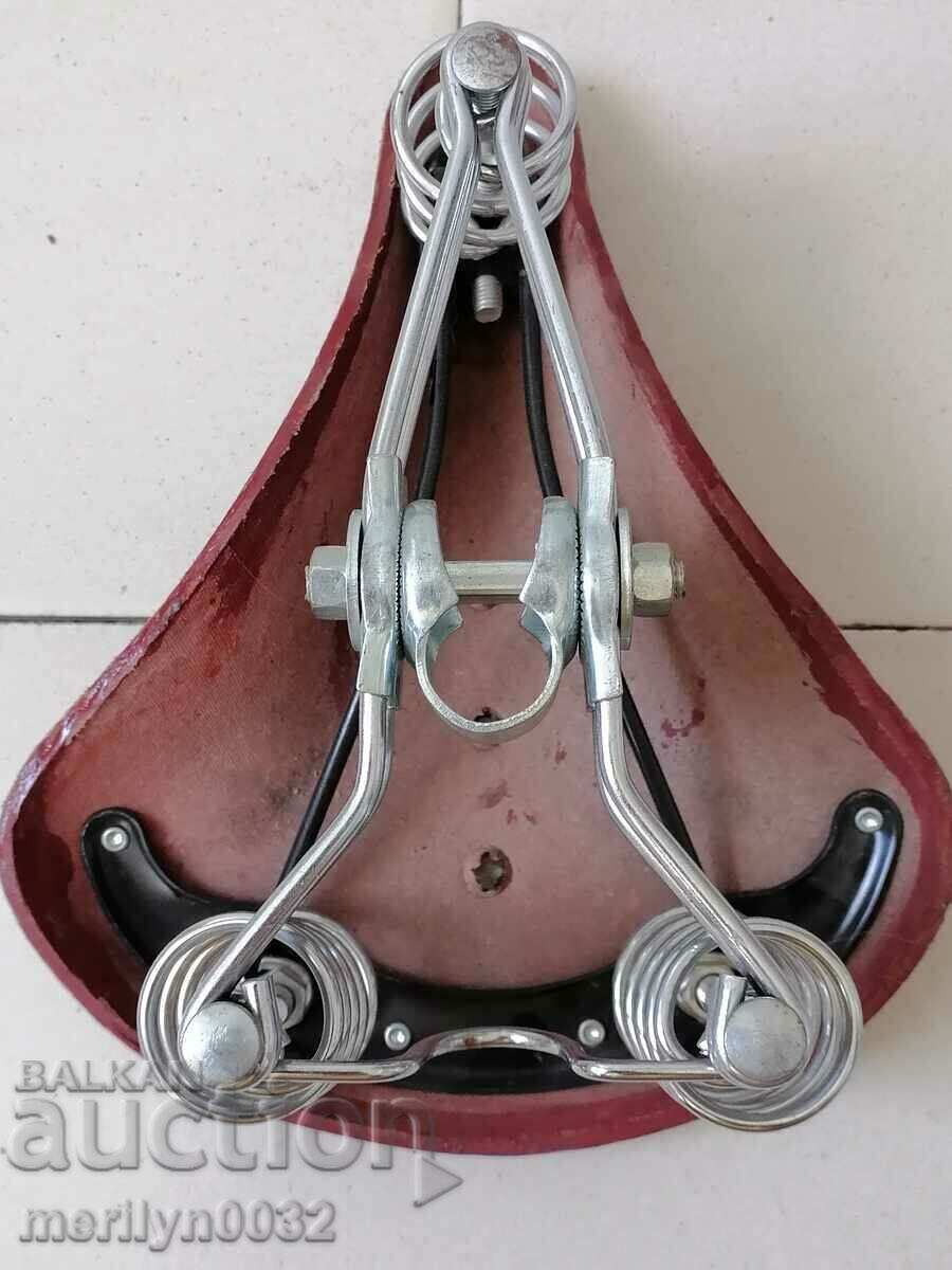Delivery of Old leather seat for bicycle, wheel