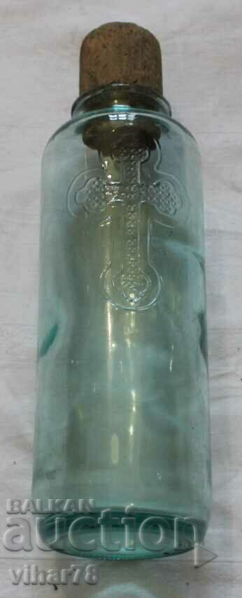 Old bottle bottle with cross and cap