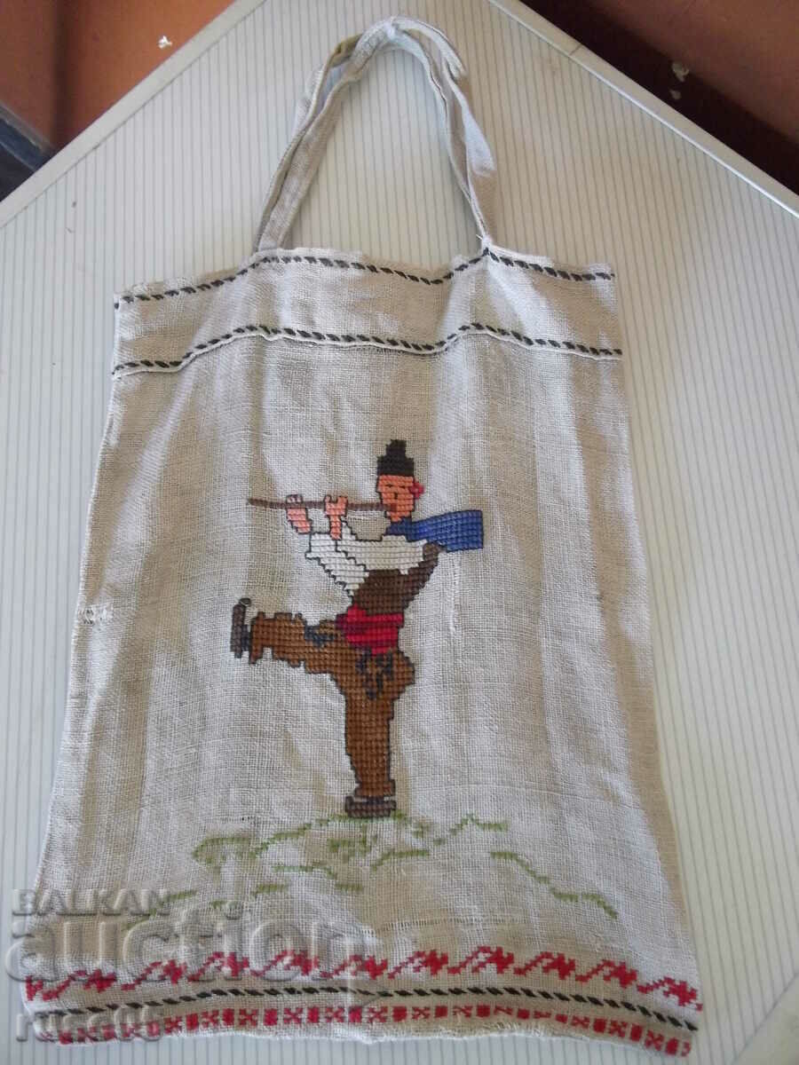 An old bag with embroidered folk dancers