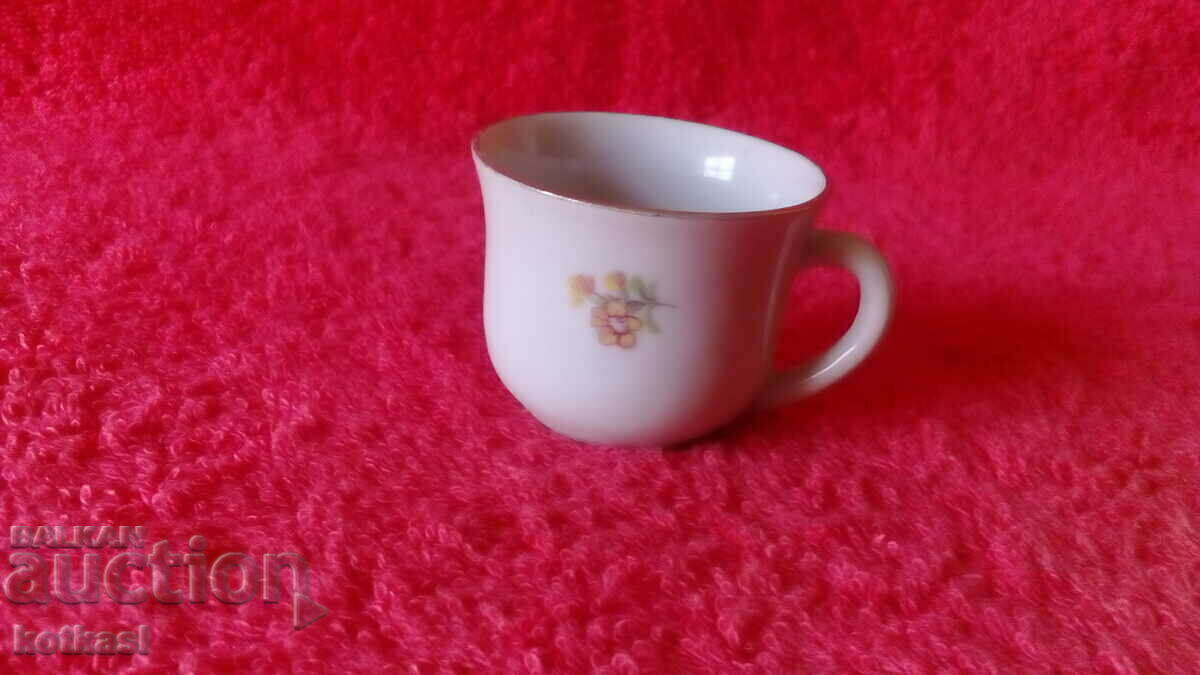 Old small porcelain cup with gold edging