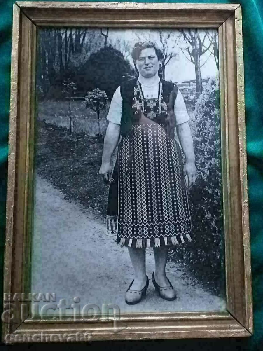 Large framed photograph of a woman in folk costume