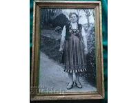 Large framed photograph of a woman in folk costume