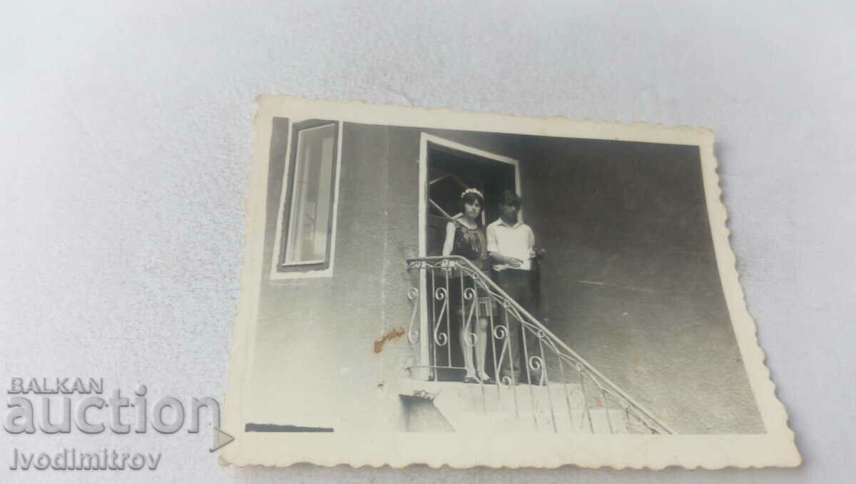 Φωτογραφία Ένας νεαρός άνδρας και ένα κορίτσι στην είσοδο του σπιτιού τους