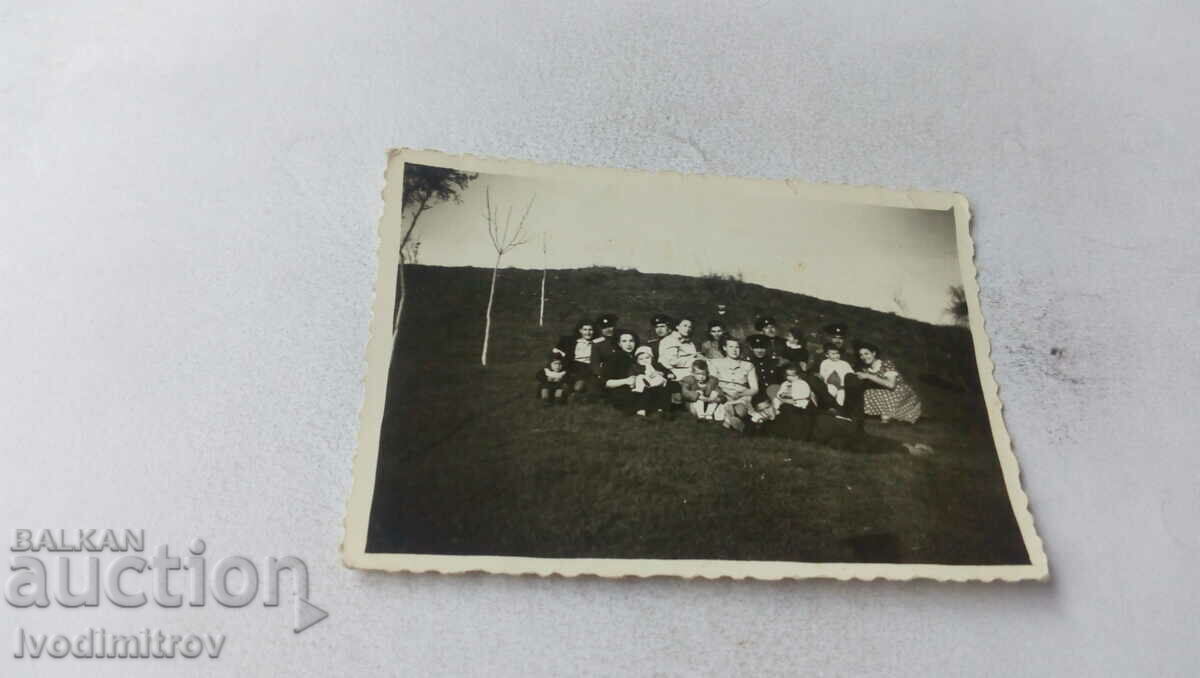 Photo Officers women and children on the meadow