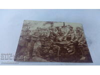 Photo Sergeants and soldiers on stones at the front 1917