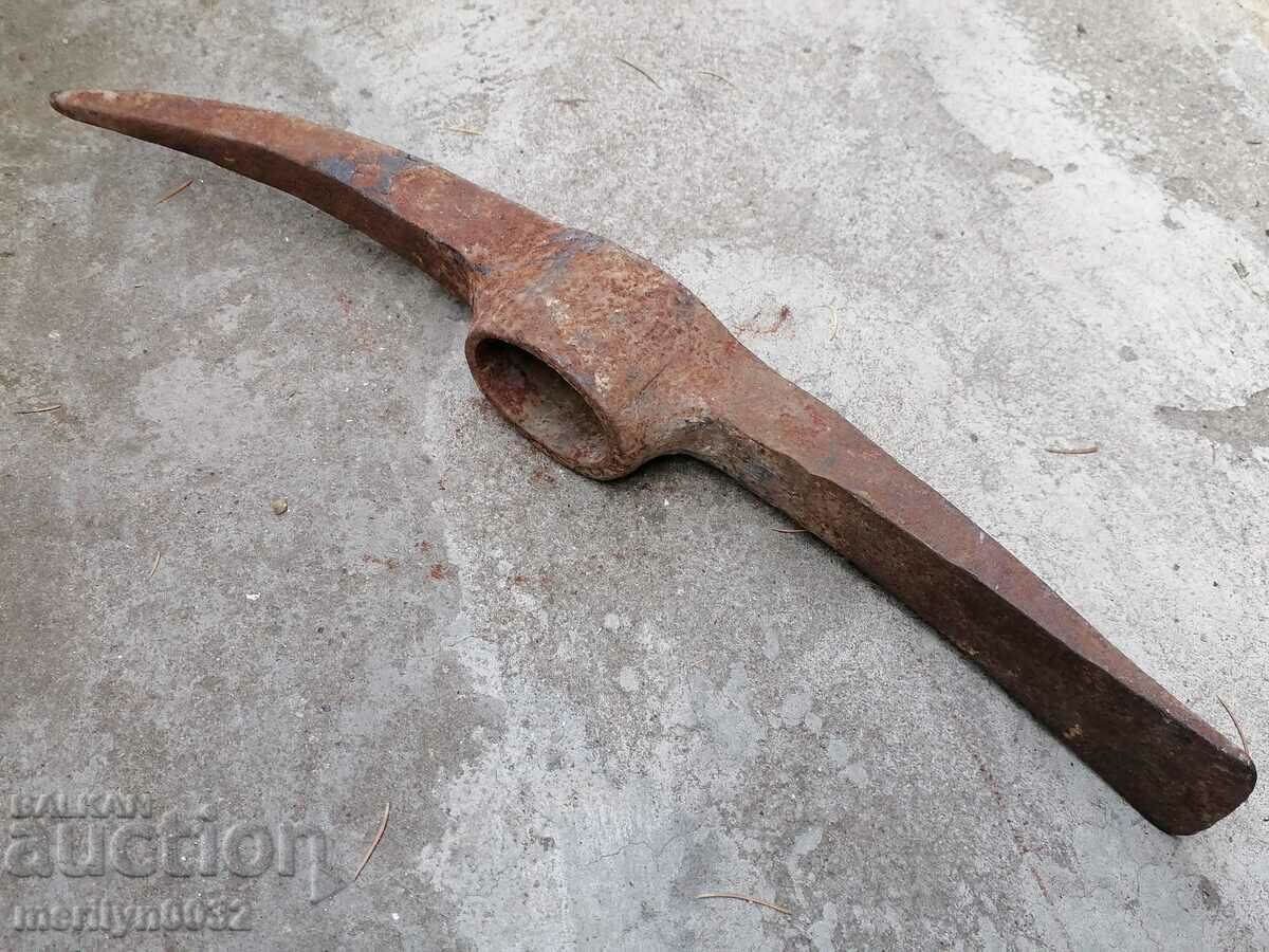 Old hand-forged pickaxe tool wrought iron