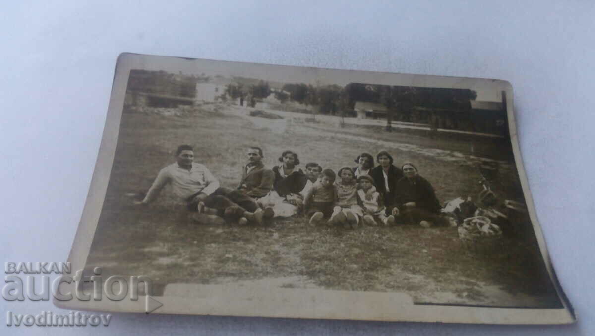 Photo Men, women and children on a picnic near the village