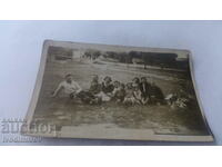 Photo Men, women and children on a picnic near the village