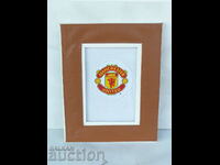 Manchester United emblem framed fans of Premiership fan