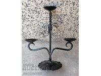An old candle made of wrought iron lamp