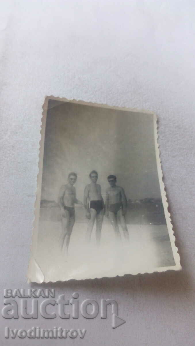 Photo Three men on the beach