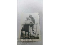 Photo Two young girls in military uniforms on the pier