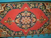 Old hand-embroidered carpet rug with wool threads