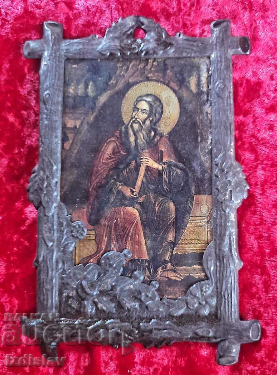 An old frame with an image of a saint placed in it An old frame with an image of a saint placed in it