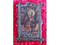 An old frame with an image of a saint placed in it