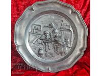 Old pewter wall plate with drinking soldiers