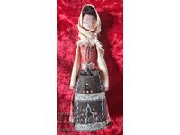 Old souvenir doll Maiden in folk costume