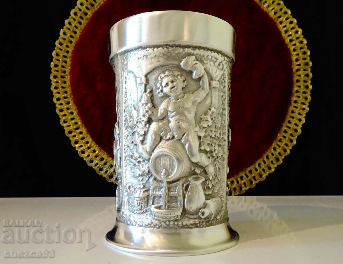 Cup, tin mug, Dionysus, wine. Cup, tin mug, Dionysus, wine.