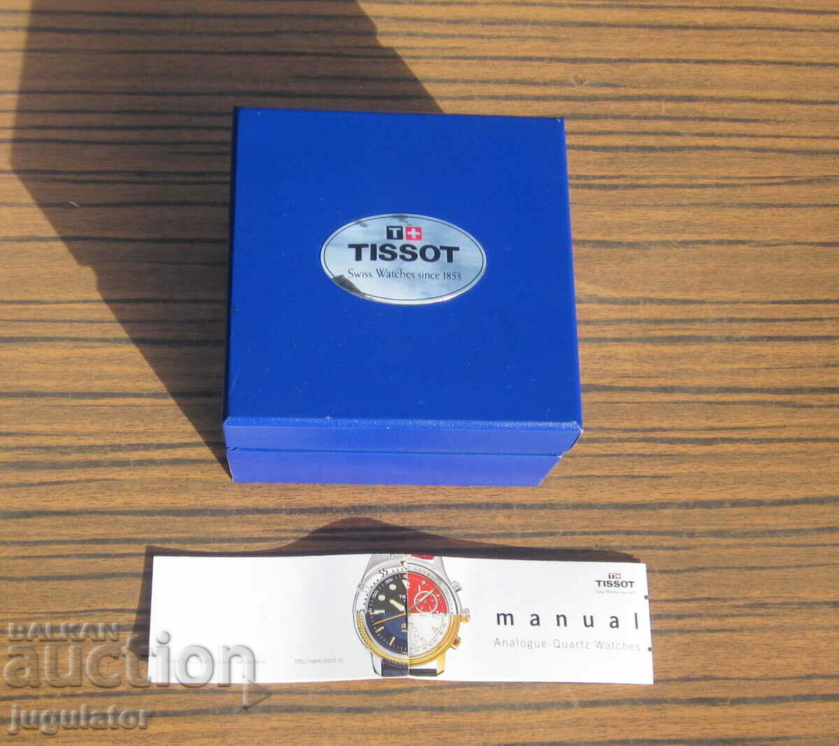 cutie goală cu broșură de la un ceas de mână TISSOT