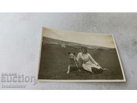 Photo Young woman with a wolf breed dog on the meadow