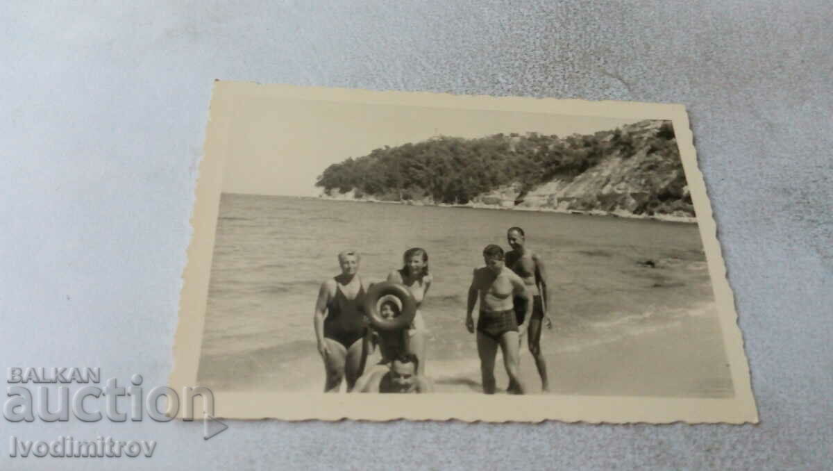 Photo Three men two women and a boy on the beach